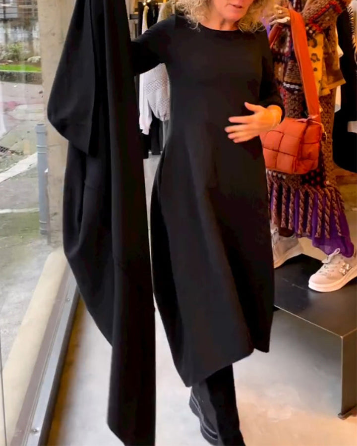Elevate Your Style with the Black Midi Dress Featuring Convenient Pockets