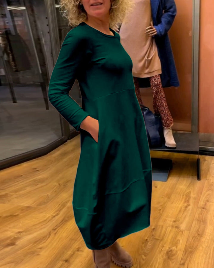 Elevate Your Style with the Black Midi Dress Featuring Convenient Pockets