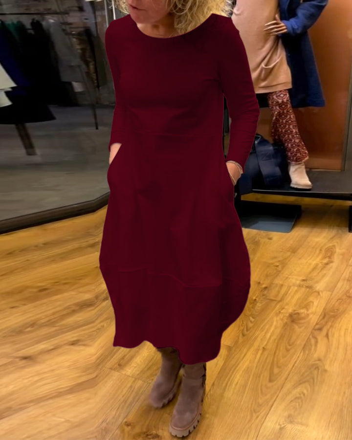 Elevate Your Style with the Black Midi Dress Featuring Convenient Pockets